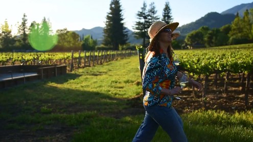 Woman walking through vineyard